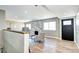 This elegant living room features wood floors and a striking fireplace, complemented by an abundance of natural light at 507 S Pontiac Way, Denver, CO 80224