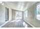 Bright sunroom featuring hardwood floors, neutral walls, and French doors to the exterior at 507 S Pontiac Way, Denver, CO 80224