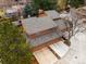Aerial view of a residential property with multiple garages, mature trees, and well-kept landscaping at 1276 Harrison Ct, Boulder, CO 80303