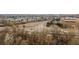 Wide aerial perspective showcasing local buildings, a highway, and the distant mountain landscape at 1276 Harrison Ct, Boulder, CO 80303