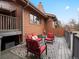 Wooden back deck featuring red outdoor furniture, and a patterned outdoor rug at 1276 Harrison Ct, Boulder, CO 80303