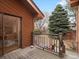 Back deck with wood railing overlooking the green backyard and adjacent evergreen trees at 1276 Harrison Ct, Boulder, CO 80303