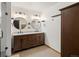 Bathroom featuring double sinks, marble countertops, round mirrors, and modern light fixtures at 1276 Harrison Ct, Boulder, CO 80303