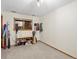 Spare bedroom or bonus room with neutral carpet, a window, and ski equipment at 1276 Harrison Ct, Boulder, CO 80303