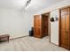 Empty bedroom featuring a neutral carpet and dark wood door with adjacent closet at 1276 Harrison Ct, Boulder, CO 80303