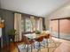 Dining room with fireplace, views of backyard, wood floors, and sliding door to outside at 1276 Harrison Ct, Boulder, CO 80303