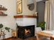 Inviting fireplace with wood mantel and white surround nestled in the dining room of this home at 1276 Harrison Ct, Boulder, CO 80303