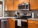 This kitchen features stainless steel appliances, granite countertops, and warm wood cabinetry at 1276 Harrison Ct, Boulder, CO 80303