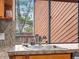 The kitchen features a stainless steel faucet and granite countertops with a view outside at 1276 Harrison Ct, Boulder, CO 80303