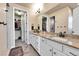 Spacious bathroom featuring double sinks with granite countertops and walk-in closet access at 18101 E 44Th Pl, Denver, CO 80249