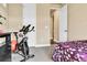 Comfortable bedroom featuring workout equipment, next to the entry and closet at 18101 E 44Th Pl, Denver, CO 80249