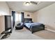 Comfortable bedroom featuring a queen bed, black accents and carpeted flooring at 18101 E 44Th Pl, Denver, CO 80249