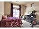 Cozy bedroom features large window, accent chair, and workout equipment at 18101 E 44Th Pl, Denver, CO 80249