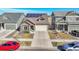 Aerial view of home with solar panels, a two-car garage, and well-maintained landscaping at 18101 E 44Th Pl, Denver, CO 80249