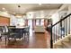 Open-concept kitchen features island seating and elegant light fixture at 18101 E 44Th Pl, Denver, CO 80249