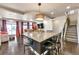 Open-concept living space features a large island, hardwood floors, and plenty of natural light at 18101 E 44Th Pl, Denver, CO 80249