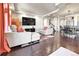 Spacious living room featuring hardwood floors, recessed lighting, and a large television at 18101 E 44Th Pl, Denver, CO 80249