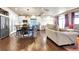 Open-concept floorplan showcasing living, dining, and kitchen area with hardwood floors at 18101 E 44Th Pl, Denver, CO 80249