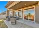 Covered patio with wicker furniture overlooking the backyard and neighborhood at 18101 E 44Th Pl, Denver, CO 80249