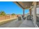 Covered patio with wicker furniture and a view of the fenced yard at 18101 E 44Th Pl, Denver, CO 80249