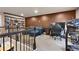 Inviting recreation room with comfortable seating, a home office, and open shelving at 18101 E 44Th Pl, Denver, CO 80249