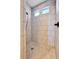 Bright walk-in shower showcasing neutral tiling and dual shower heads at 18101 E 44Th Pl, Denver, CO 80249