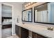 Bright bathroom featuring a double vanity with framed mirrors, a shower-tub combo, and tile flooring at 398 Benton St, Castle Rock, CO 80104