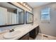 Bright bathroom featuring a double vanity with framed mirrors, a shower-tub combo, and tile flooring at 398 Benton St, Castle Rock, CO 80104