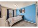Sports themed bedroom with blue accent wall and carpeted flooring at 398 Benton St, Castle Rock, CO 80104