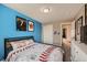 Sports themed bedroom with blue accent wall and carpeted flooring at 398 Benton St, Castle Rock, CO 80104