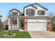 Charming two-story home with a well-manicured lawn, attached two-car garage, and attractive curb appeal at 398 Benton St, Castle Rock, CO 80104