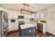 Modern kitchen featuring white cabinets, stainless steel appliances, and a center island at 398 Benton St, Castle Rock, CO 80104