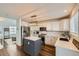 Well-lit kitchen boasts stainless steel appliances, subway tile backsplash, and center island at 398 Benton St, Castle Rock, CO 80104