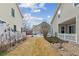 Backyard view showcasing the space between houses with a mix of grass and rock landscaping at 4733 Flower St, Wheat Ridge, CO 80033