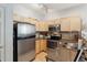 Efficient kitchen featuring stainless steel appliances, granite countertops, and ample cabinets at 4733 Flower St, Wheat Ridge, CO 80033