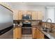 Efficient kitchen featuring stainless steel appliances, granite countertops, and ample cabinets at 4733 Flower St, Wheat Ridge, CO 80033