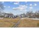 Community landscape featuring a walking path lined by trees and a mix of single Gathering homes and townhouses at 4733 Flower St, Wheat Ridge, CO 80033