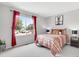 Bright bedroom features large window, plush carpet, and comfortable furnishings at 6662 Fonder Dr, Parker, CO 80134