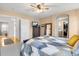 Large bedroom with carpeted floors, a wooden framed mirror, and access to an adjoining bathroom at 6662 Fonder Dr, Parker, CO 80134