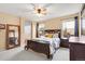 Well lit bedroom featuring carpeted floors, a ceiling fan, and a decorative, wooden framed mirror at 6662 Fonder Dr, Parker, CO 80134