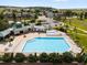 Community pool featuring ample seating, a picnic area, and mature landscaping surrounded by residential homes in the neighborhood at 6662 Fonder Dr, Parker, CO 80134