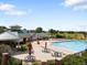 Community pool area with lounge chairs, umbrellas, and lush landscaping at 6662 Fonder Dr, Parker, CO 80134