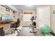 Finished basement exercise room and desk space with workout equipment at 6662 Fonder Dr, Parker, CO 80134