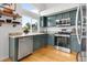 Well lit kitchen featuring stainless steel appliances, granite countertops, and dark green cabinetry at 6662 Fonder Dr, Parker, CO 80134