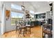 Eat-in kitchen featuring high ceilings, updated appliances, a view of the backyard, and a dining table for casual dining at 6662 Fonder Dr, Parker, CO 80134