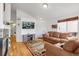Cozy living room featuring a fireplace, hardwood floors, a plush leather sofa, and a mounted television for relaxing entertainment at 6662 Fonder Dr, Parker, CO 80134
