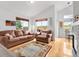 Bright living room with high ceilings, hardwood floors, large windows, and comfortable leather furniture creating an inviting atmosphere at 6662 Fonder Dr, Parker, CO 80134