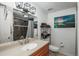 Bathroom with single vanity, mirror, shower, and decorative wall art at 532 Oakwood Dr # D202, Castle Rock, CO 80104