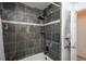 Shower with dark tile, rain shower head, and niche shelf at 532 Oakwood Dr # D202, Castle Rock, CO 80104