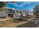 Charming row of townhomes with balconies, black trim, and lovely landscaping at 532 Oakwood Dr # D202, Castle Rock, CO 80104